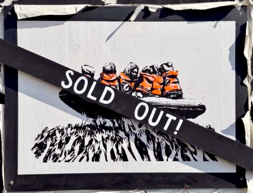 Banksy Inflatable Raft Migrant raft poster at Glastonbury. 19 July 2025 – Banksy unofficial